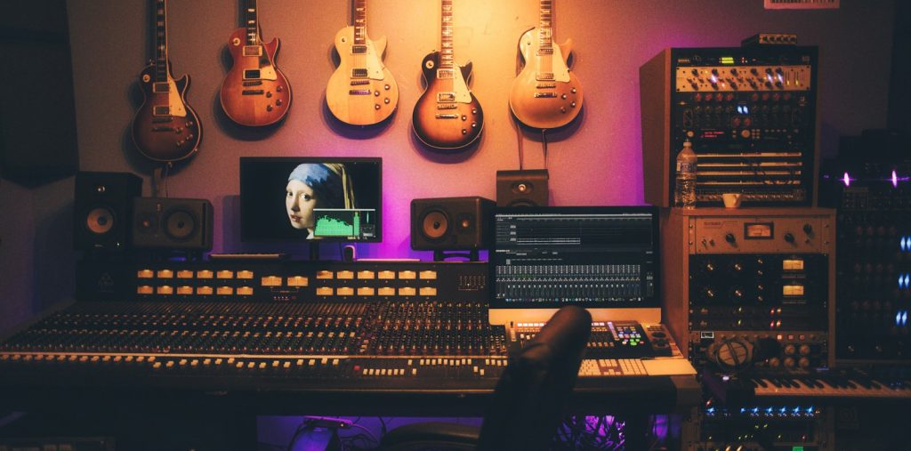 person playing brown and white acoustic guitars